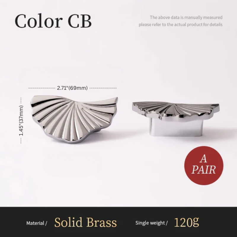 Two silver shell-shaped knobs with measurements and material details on a white background