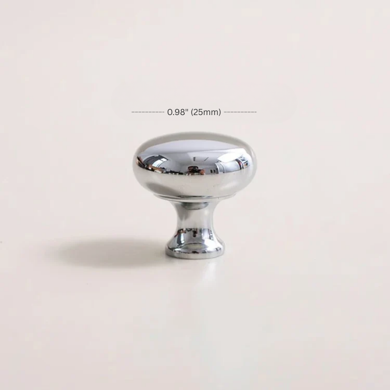 Chrome cabinet knob with measurement label on a light beige background