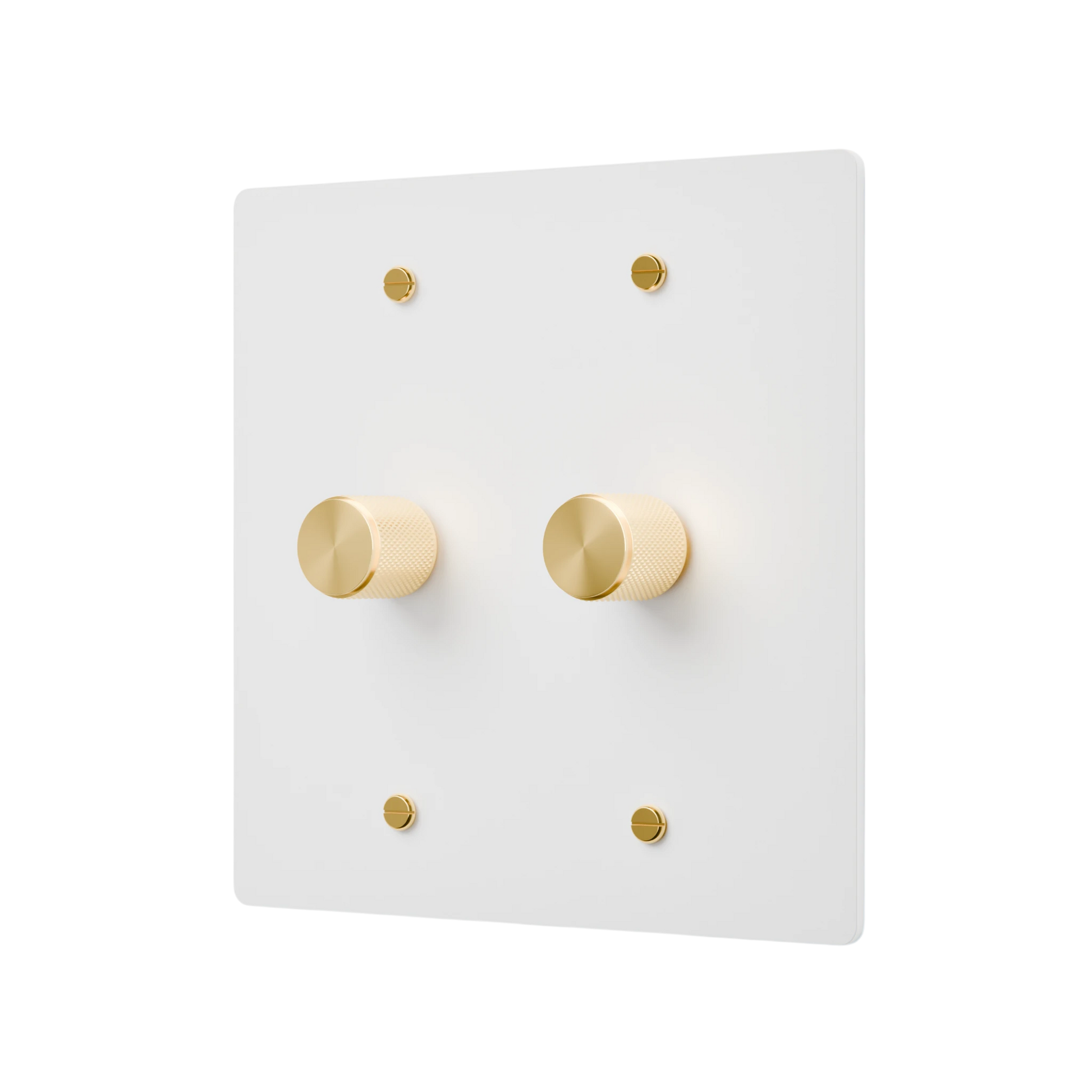 White wall switch plate with gold knobs on a white background