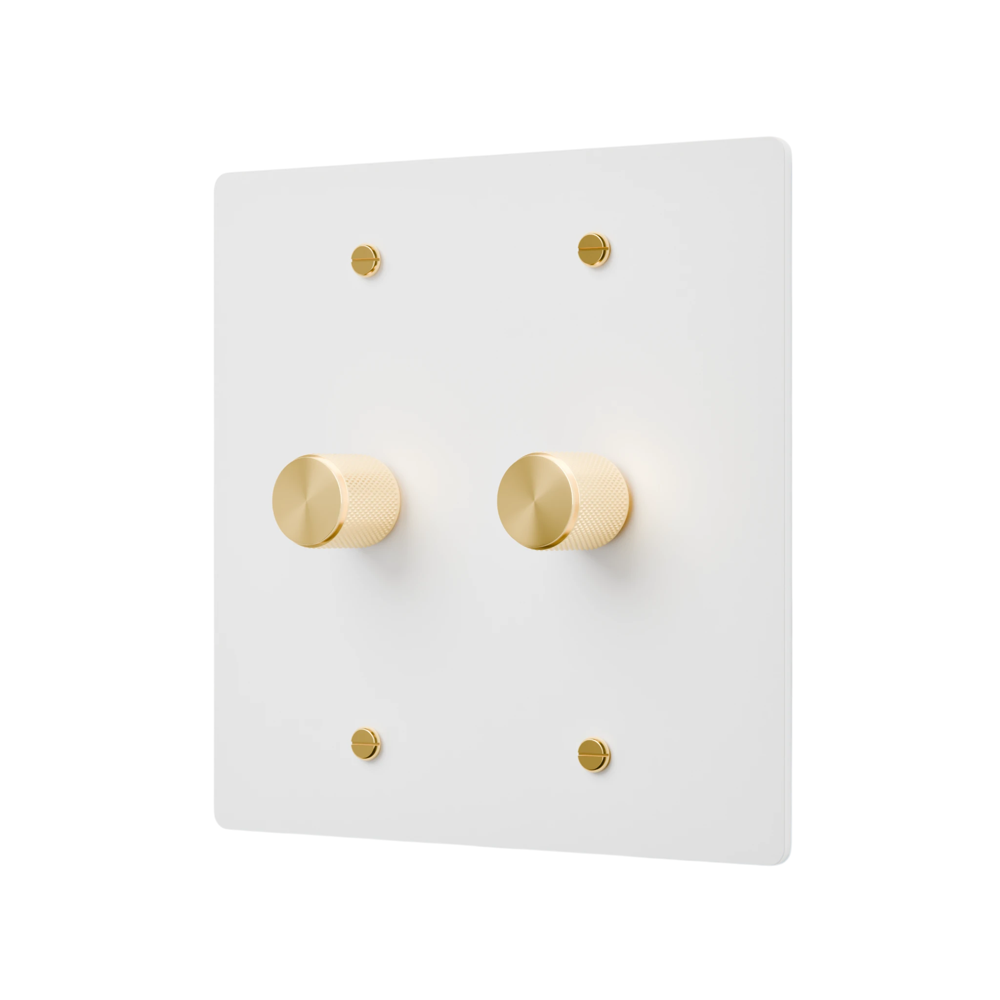 White wall switch plate with gold knobs on a white background