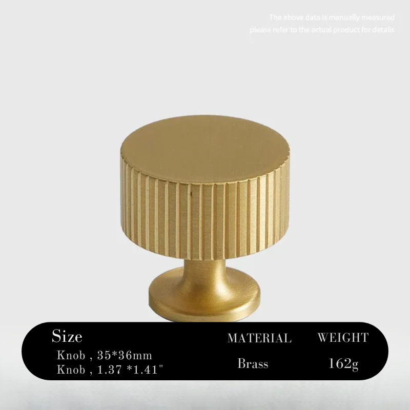 Gold cylindrical knob with ribbed texture on a white background