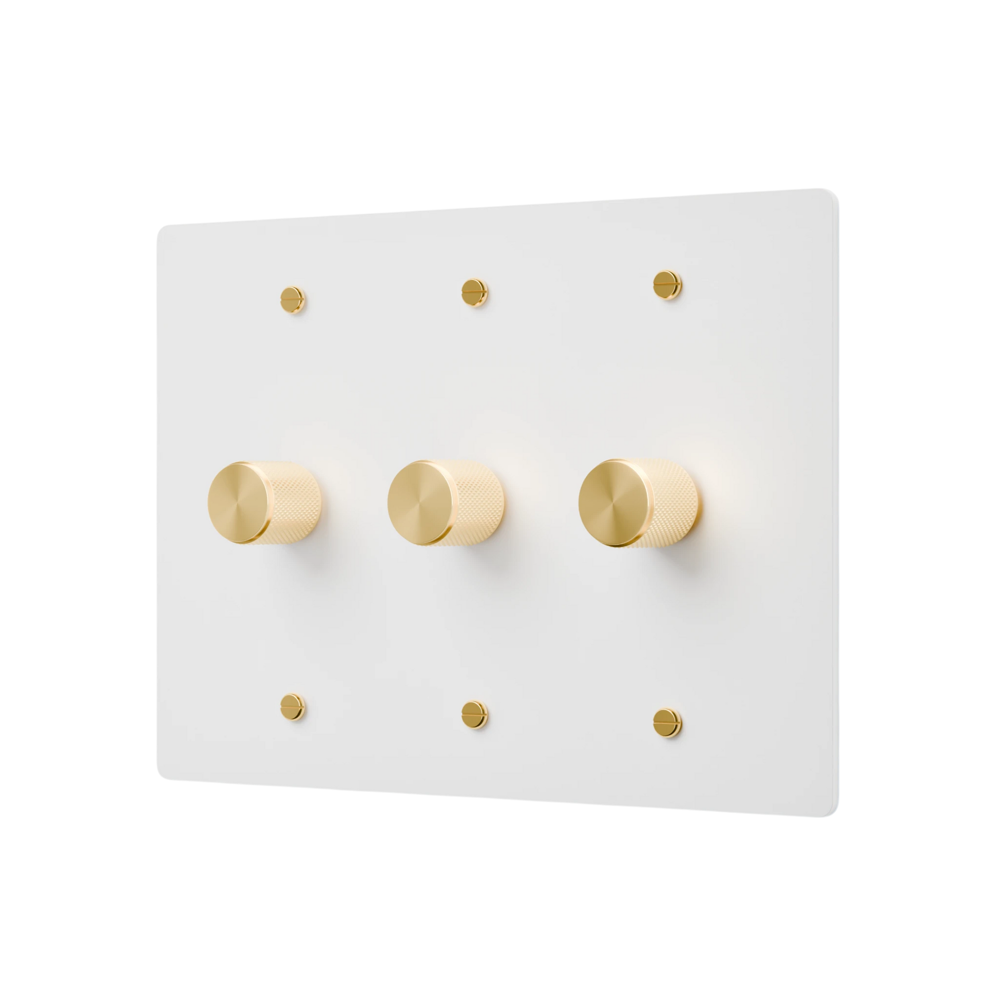 White wall plate with gold knobs on a white background