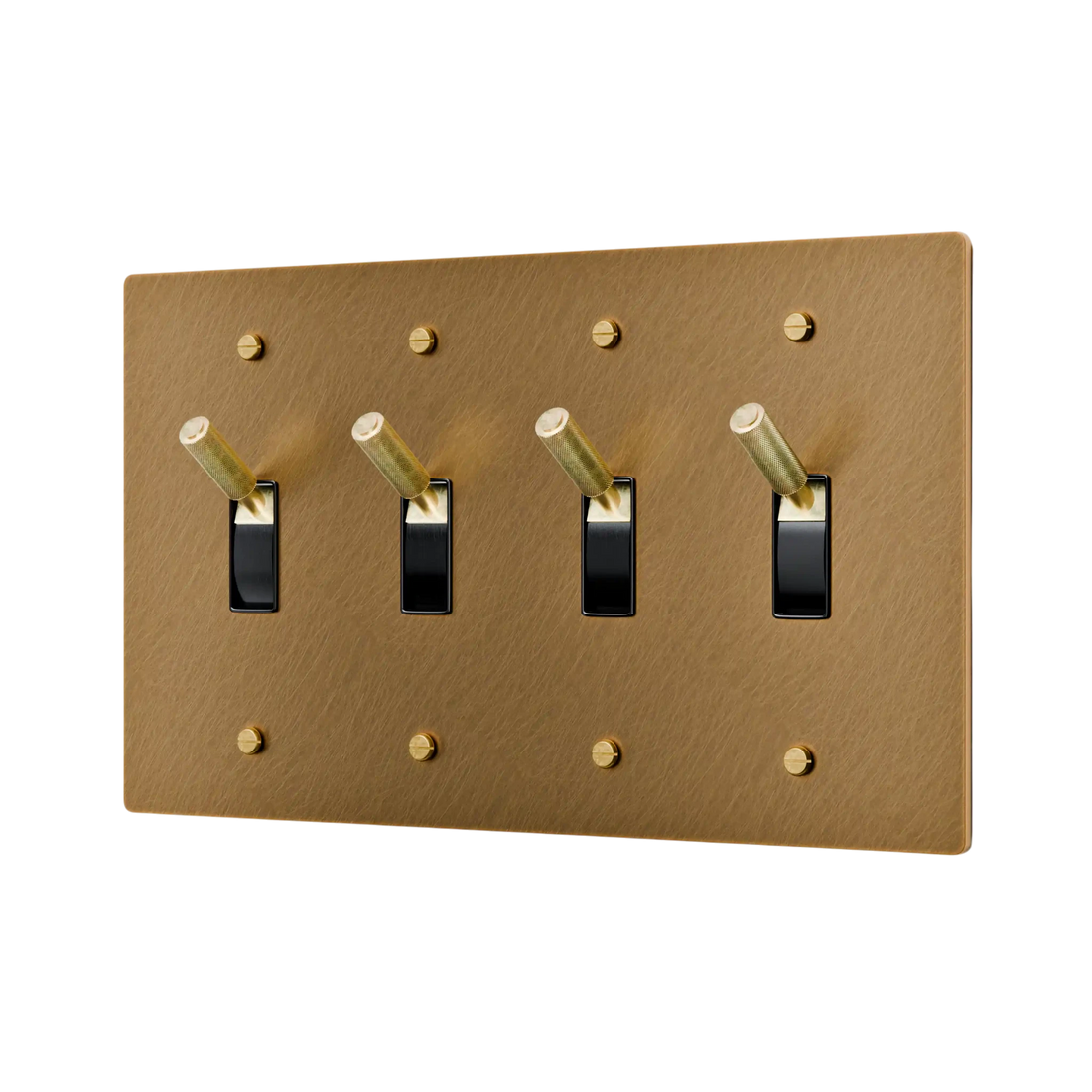 Aged brass light switch panel with four black switches on a white background
