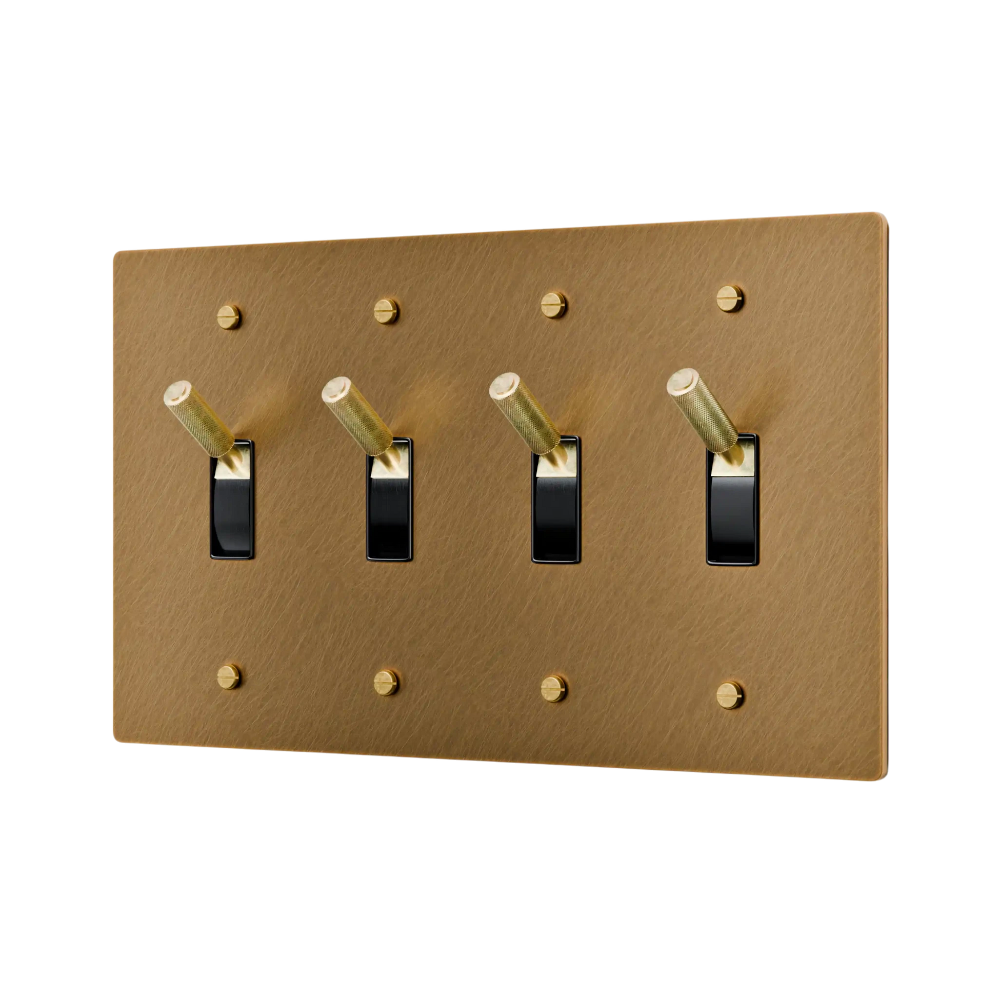 Aged brass light switch panel with four black switches on a white background