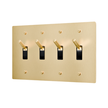 Gold light switch panel with four black switches on a white background