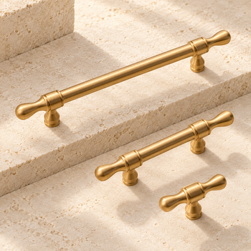 Brushed Brass Drop-Shaped Solid Brass Cabinet Pulls & Knobs on warm ivory stone