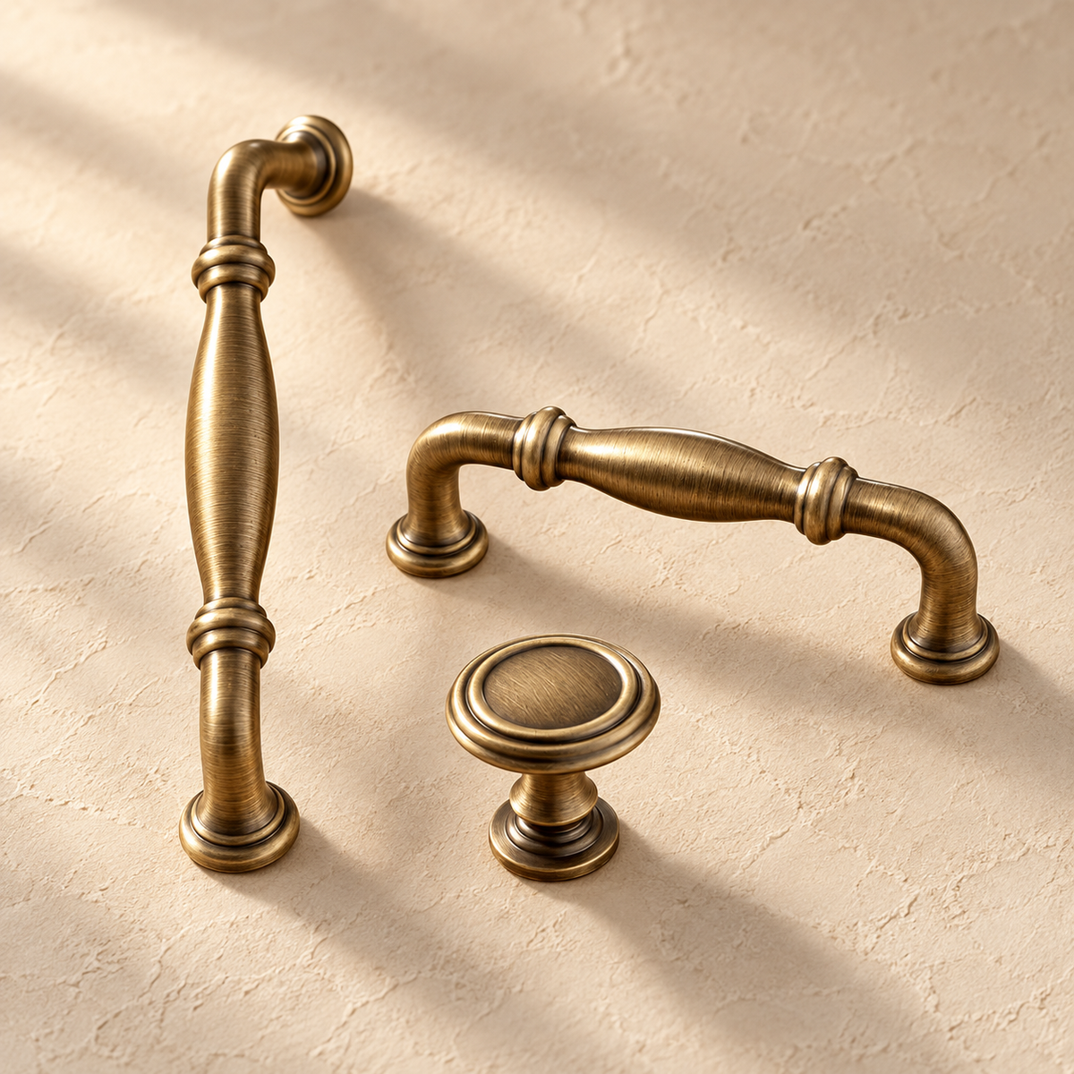 European Solid Brass Cabinet Pulls & Knobs — Antique Brass on a warm ivory background
