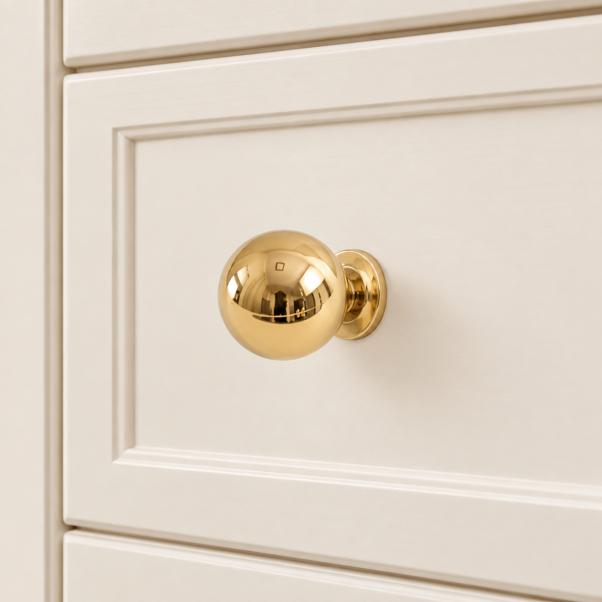 Ball Cabinet Knobs — Polished Brass installed on warm ivory cabinetry