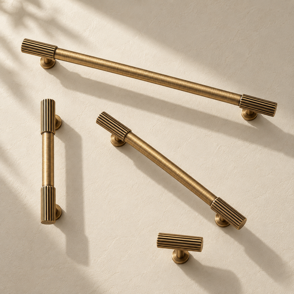 Ribbed Solid Brass Cabinet Pulls & Knobs — Antique Brass on a warm ivory background
