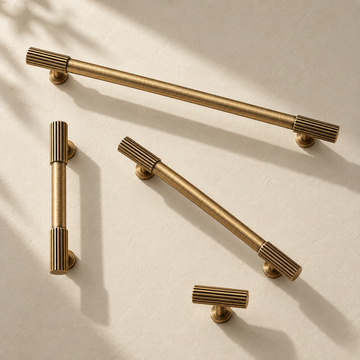 Ribbed Solid Brass Cabinet Pulls & Knobs — Antique Brass on a warm ivory background