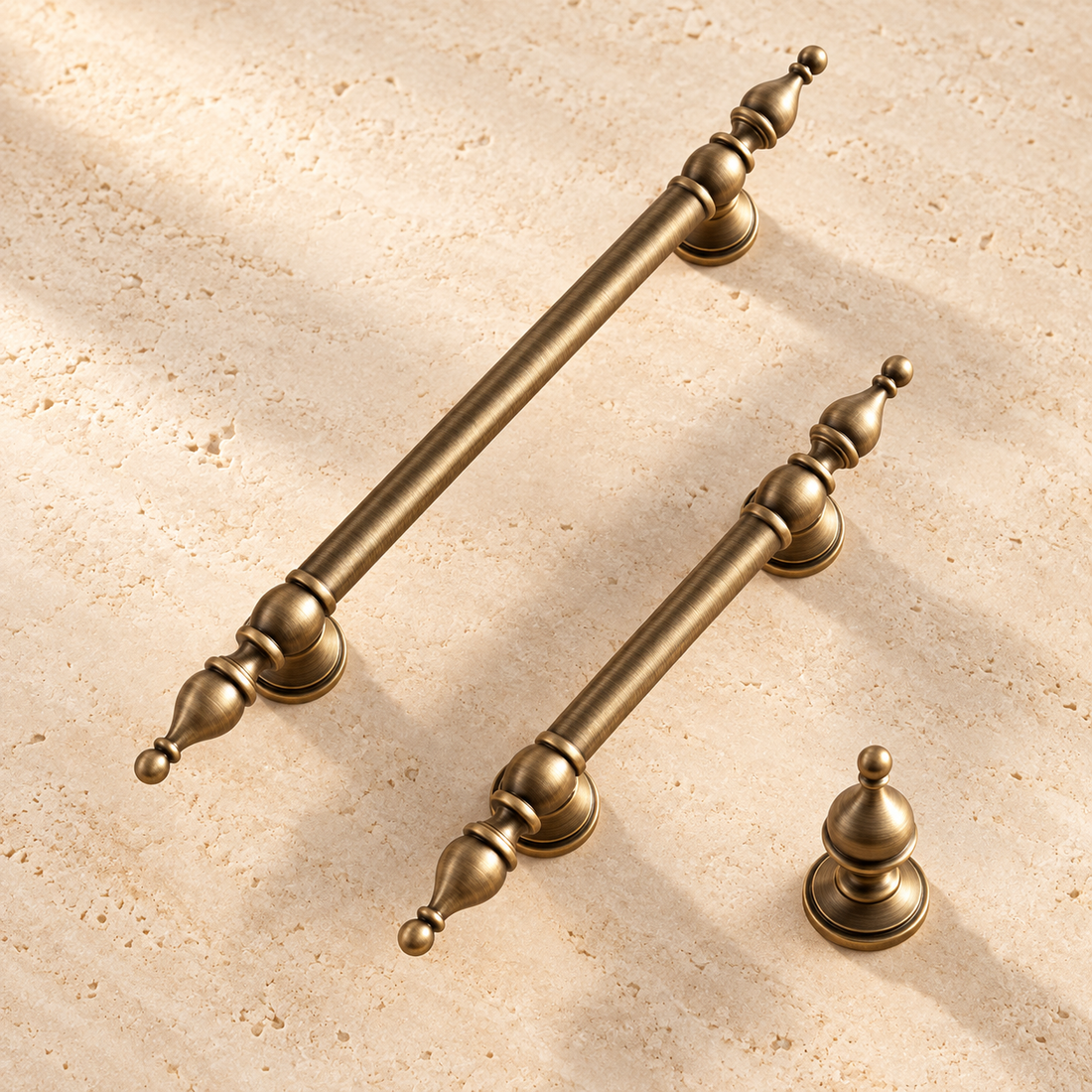 Antique Brass Solid Brass Cabinet Pulls & Knobs — Crown Design on warm ivory stone