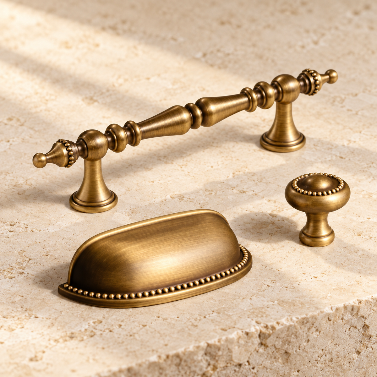 Antique Brass Solid Brass Cabinet Pulls & Knobs — Geometric Design on warm ivory stone