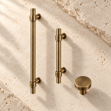 Antique Brass Solid Brass Cabinet Pulls & Knobs — Simple Modern Design on warm ivory stone