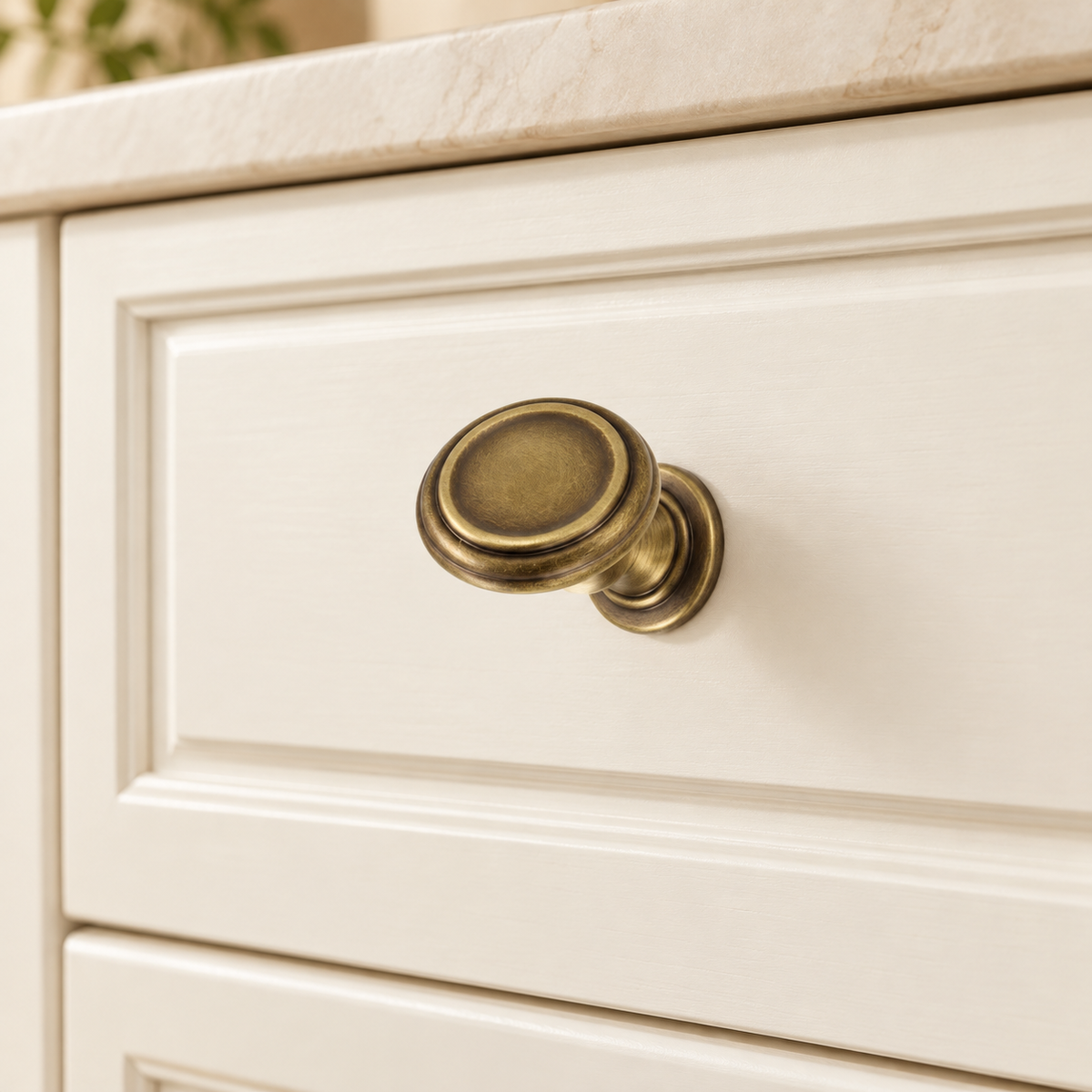 Antique Brass Solid Brass Cabinet Pulls & Knobs — Classic Turret Design installed on warm ivory cabinetry