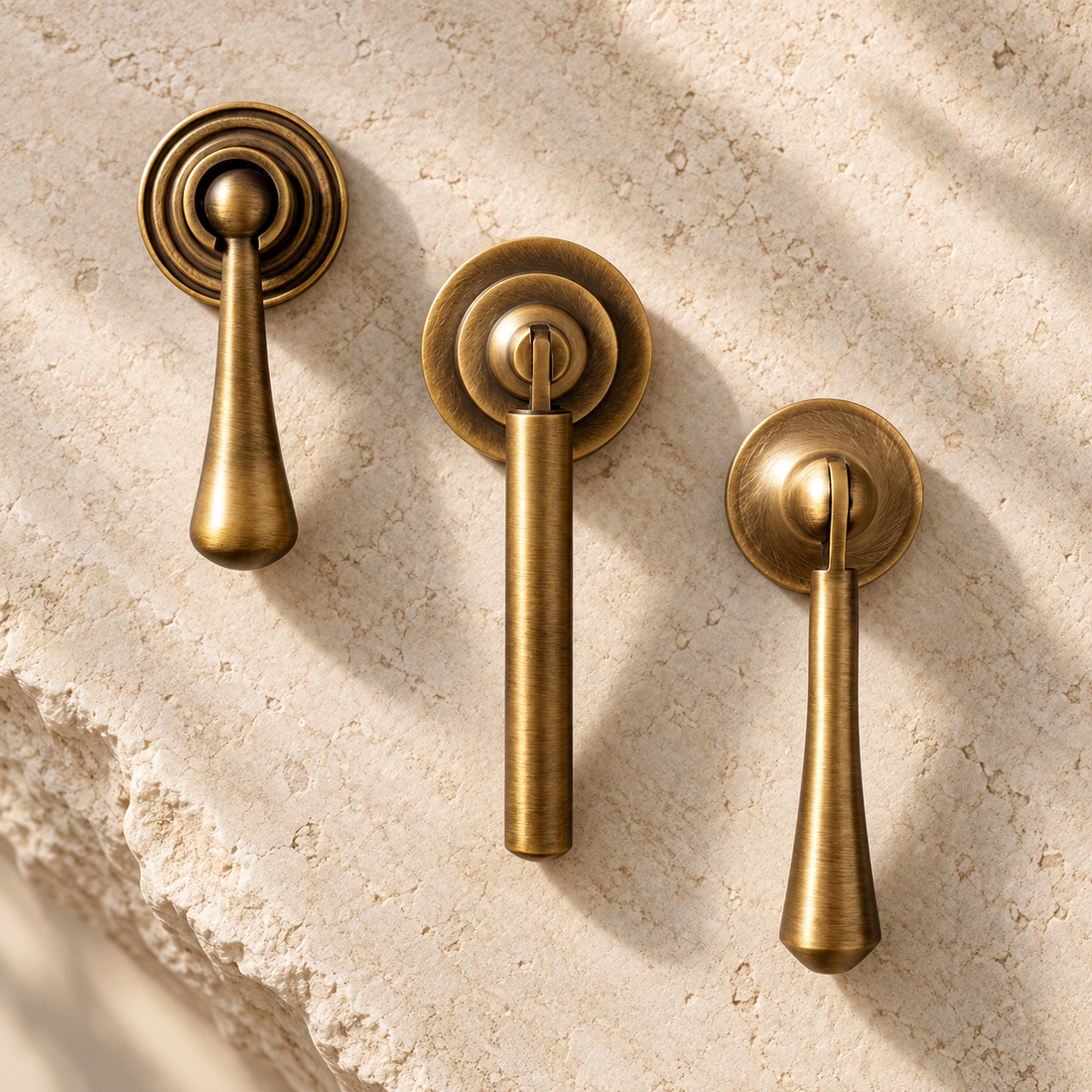 Brushed Antique Brass Cabinet Handle & Knob — Tear Drop Design on warm ivory stone