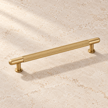Brushed Brass Ribbed Cabinet Pull — Solid Brass on warm ivory stone