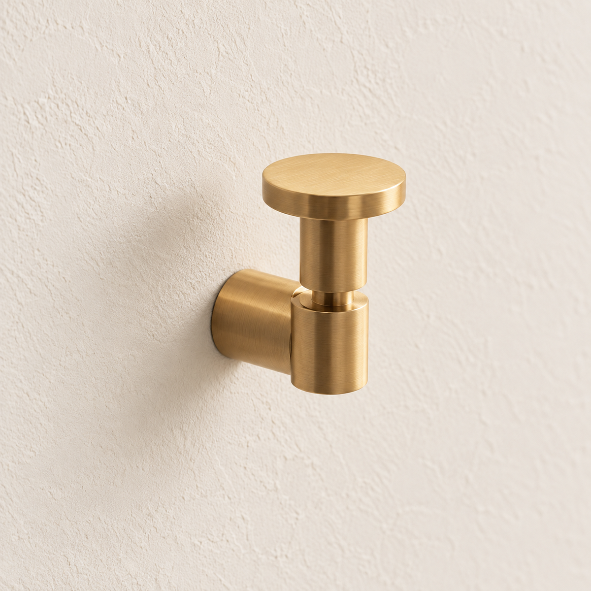 Brass Wall Hook — Brushed Brass Finish installed on warm ivory cabinetry
