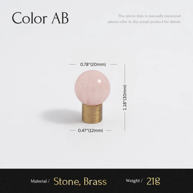 Measurement chart with a pink stone and brass base on a light gray background