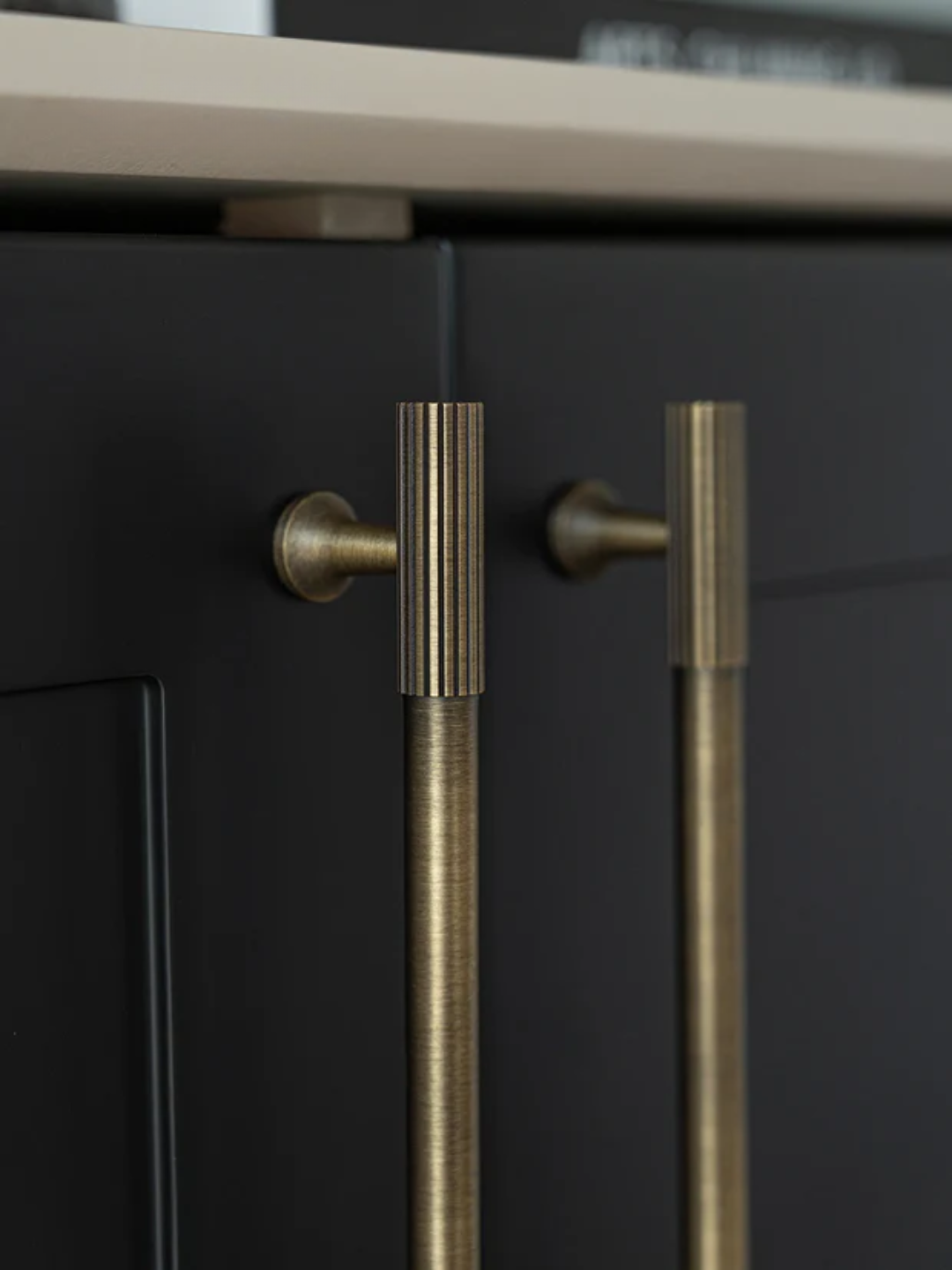 Set of gold cabinet handles on a light surface