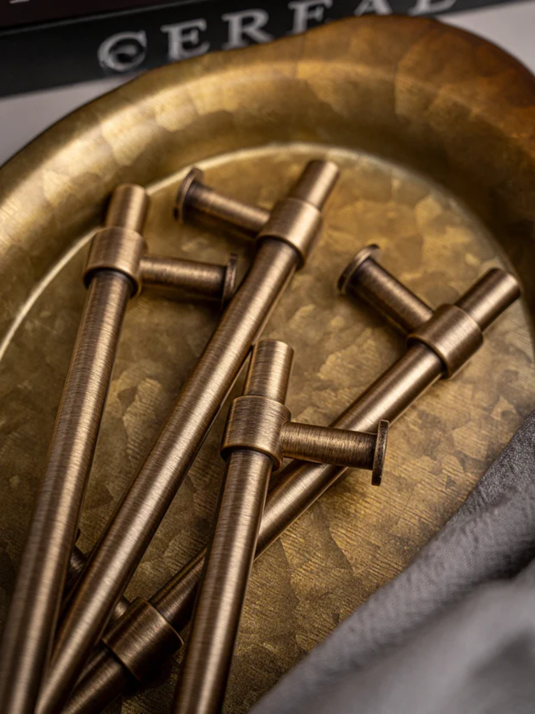 Bronze cylindrical objects on a textured bronze surface