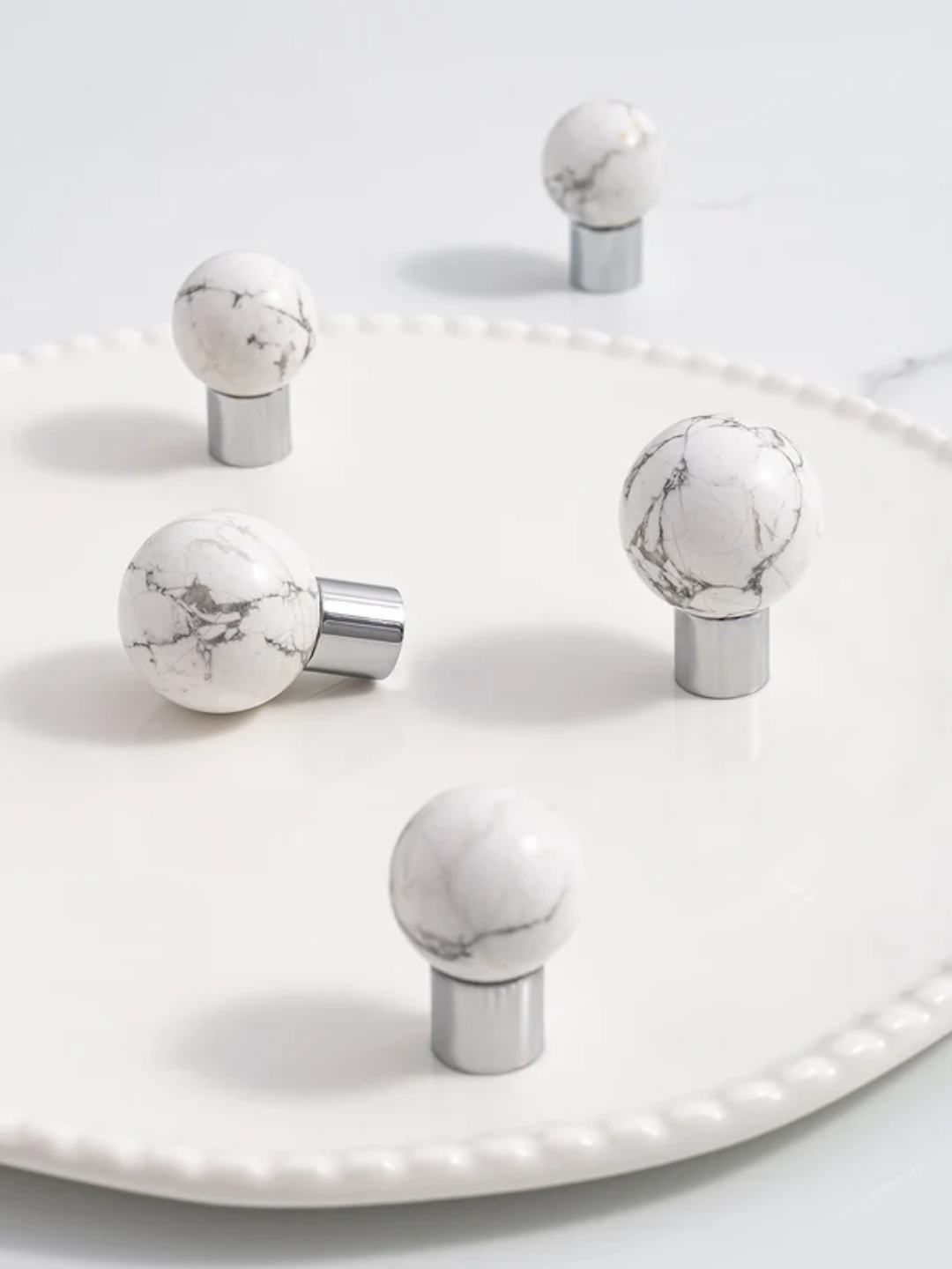Marble-textured knobs on a white surface with 'Santaya' branding.