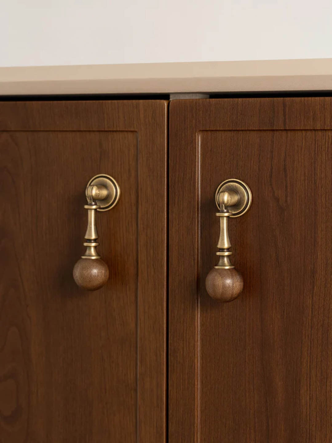 Wooden cabinet doors with brass handles on a white background