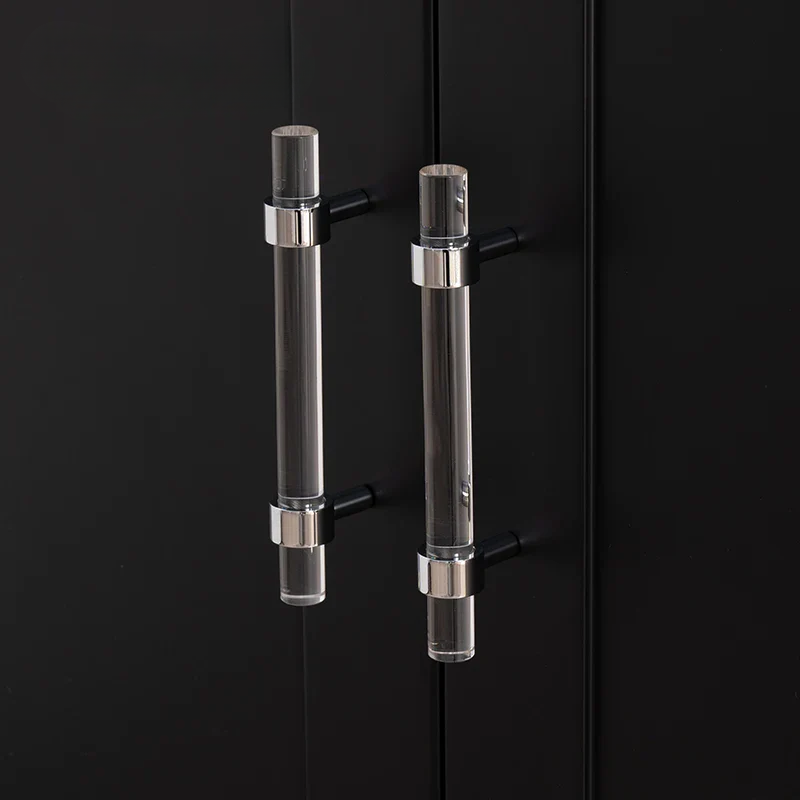 Clear glass cabinet handles on a black cabinet