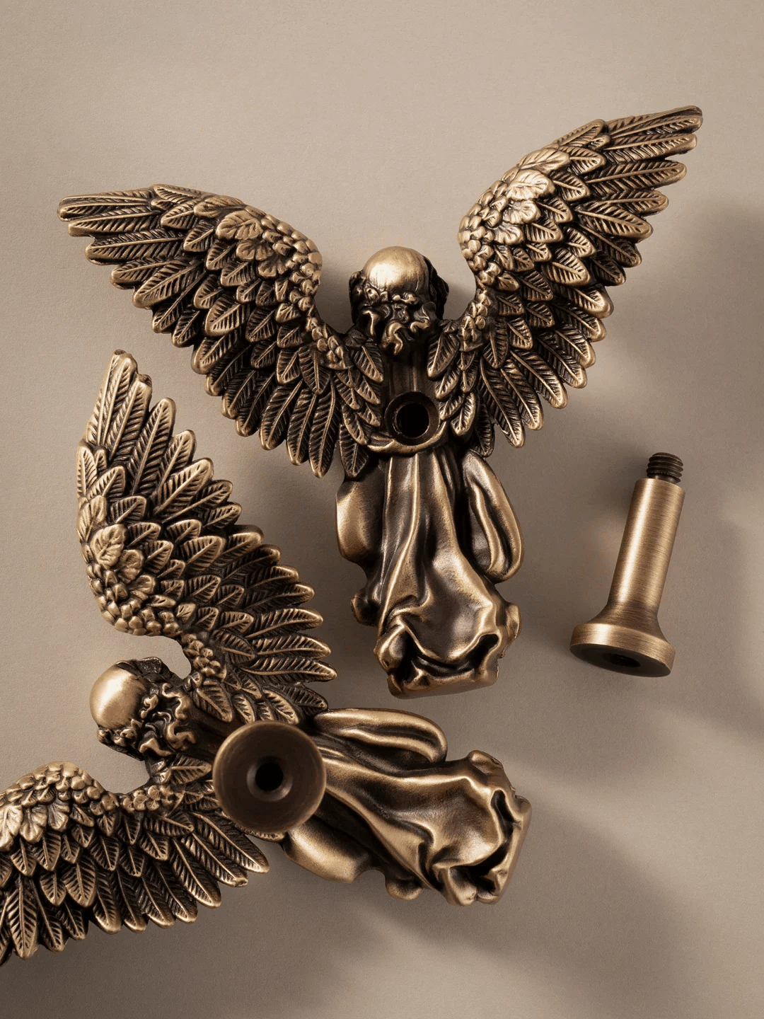 Bronze angel figurine on a beige background