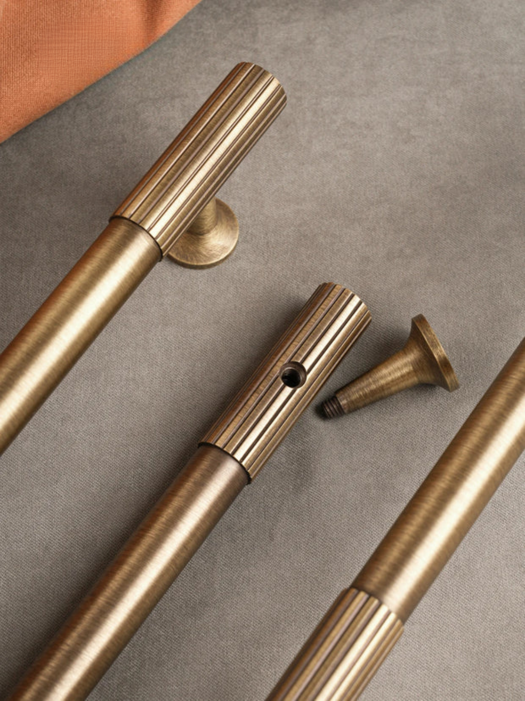 Brass hardware components on a gray surface