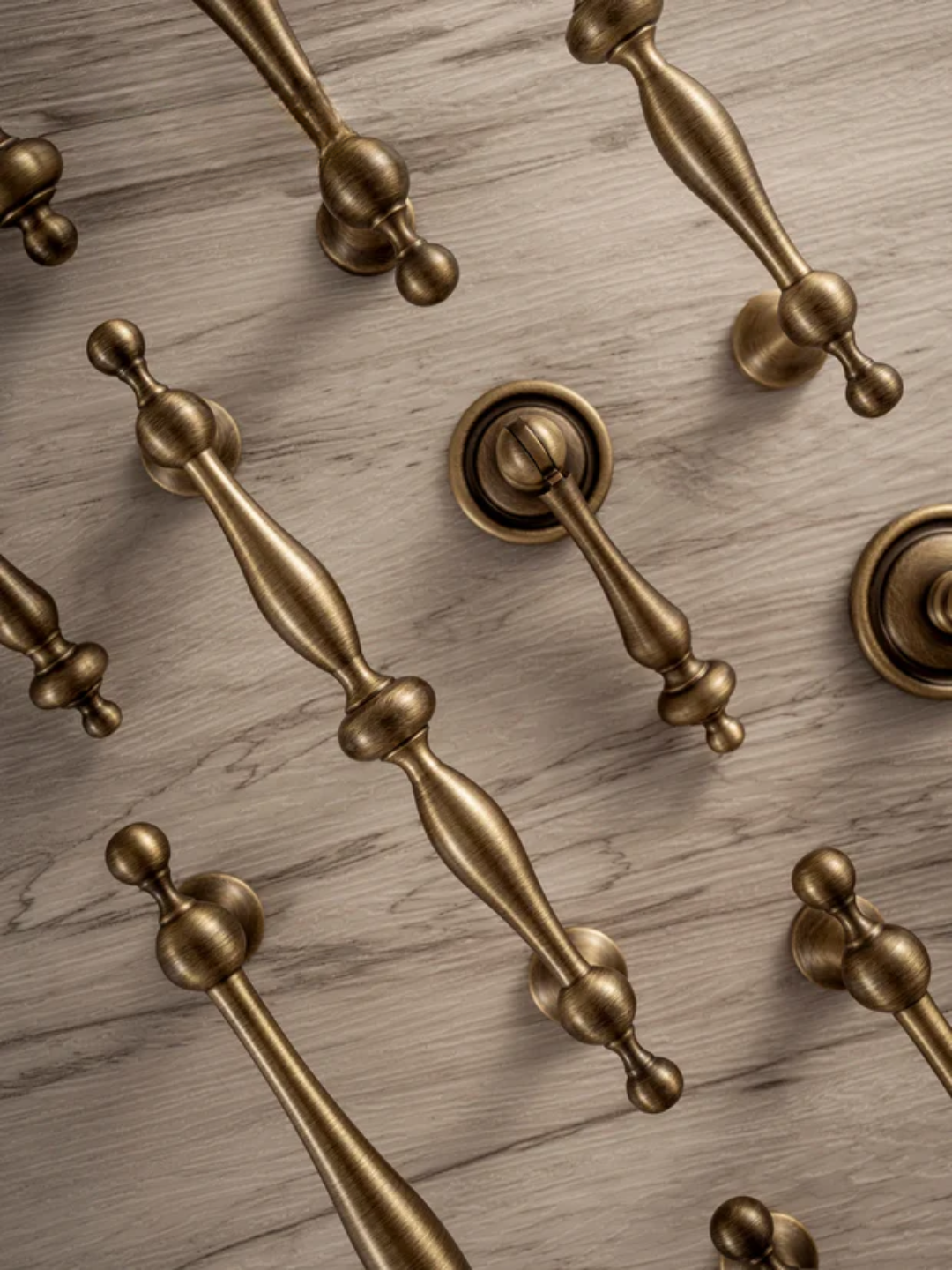 Close-up of gold door handles on a wooden surface