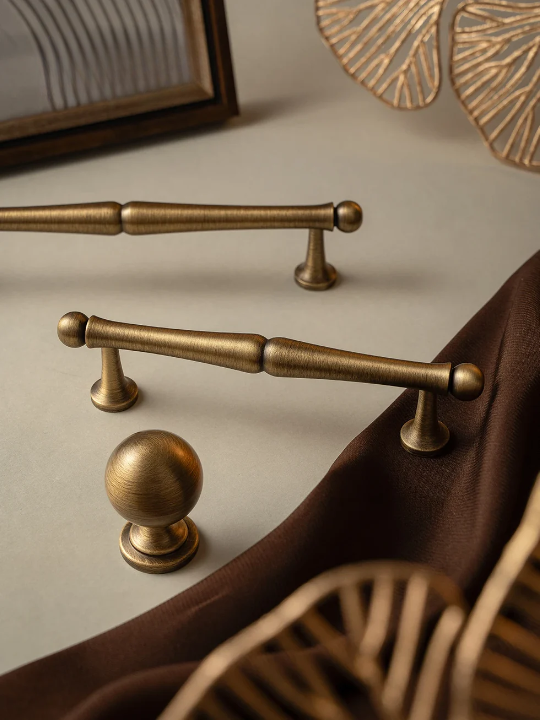 Set of bronze cabinet handles on a neutral background