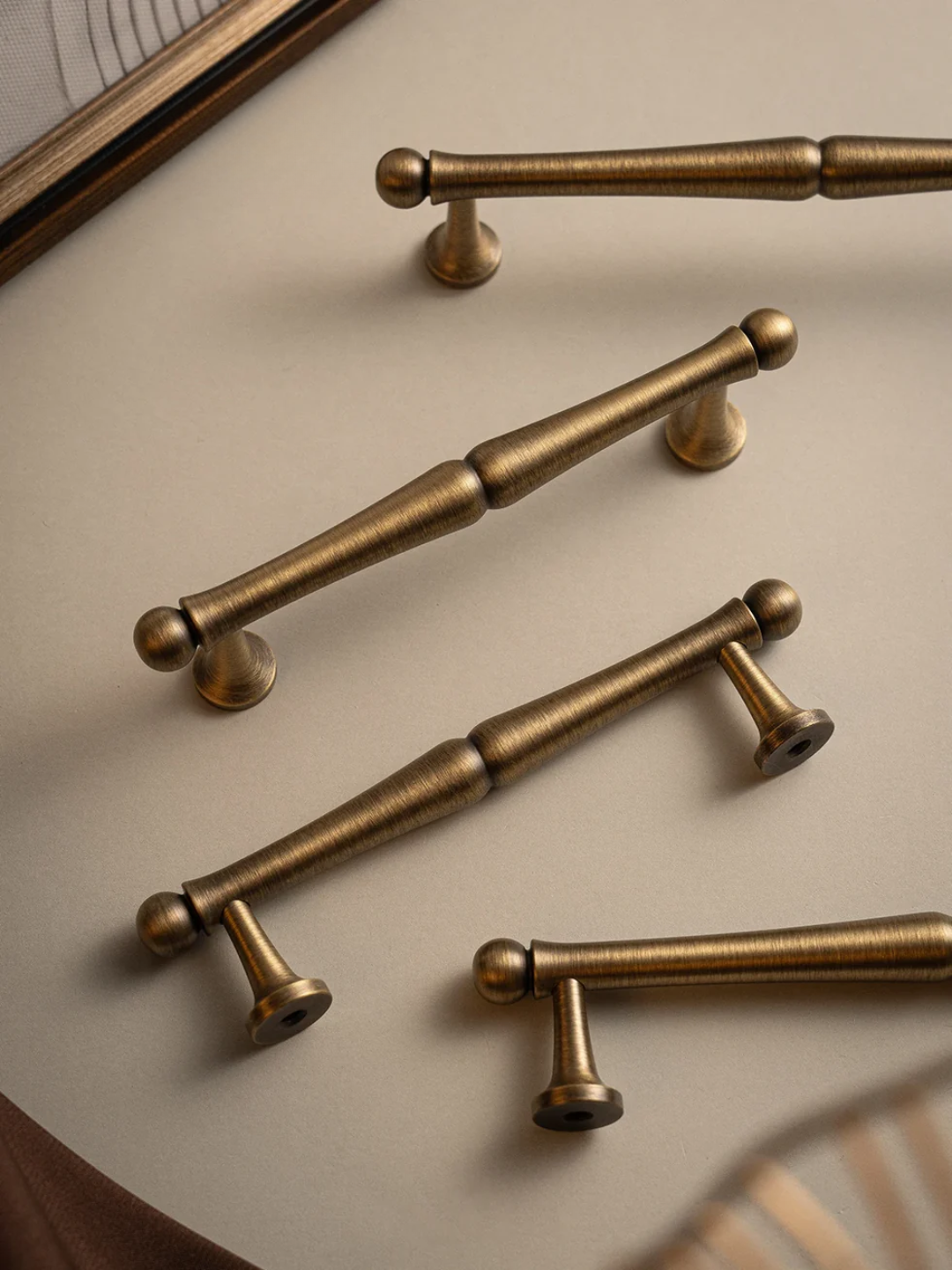 Set of bronze cabinet handles on a neutral background