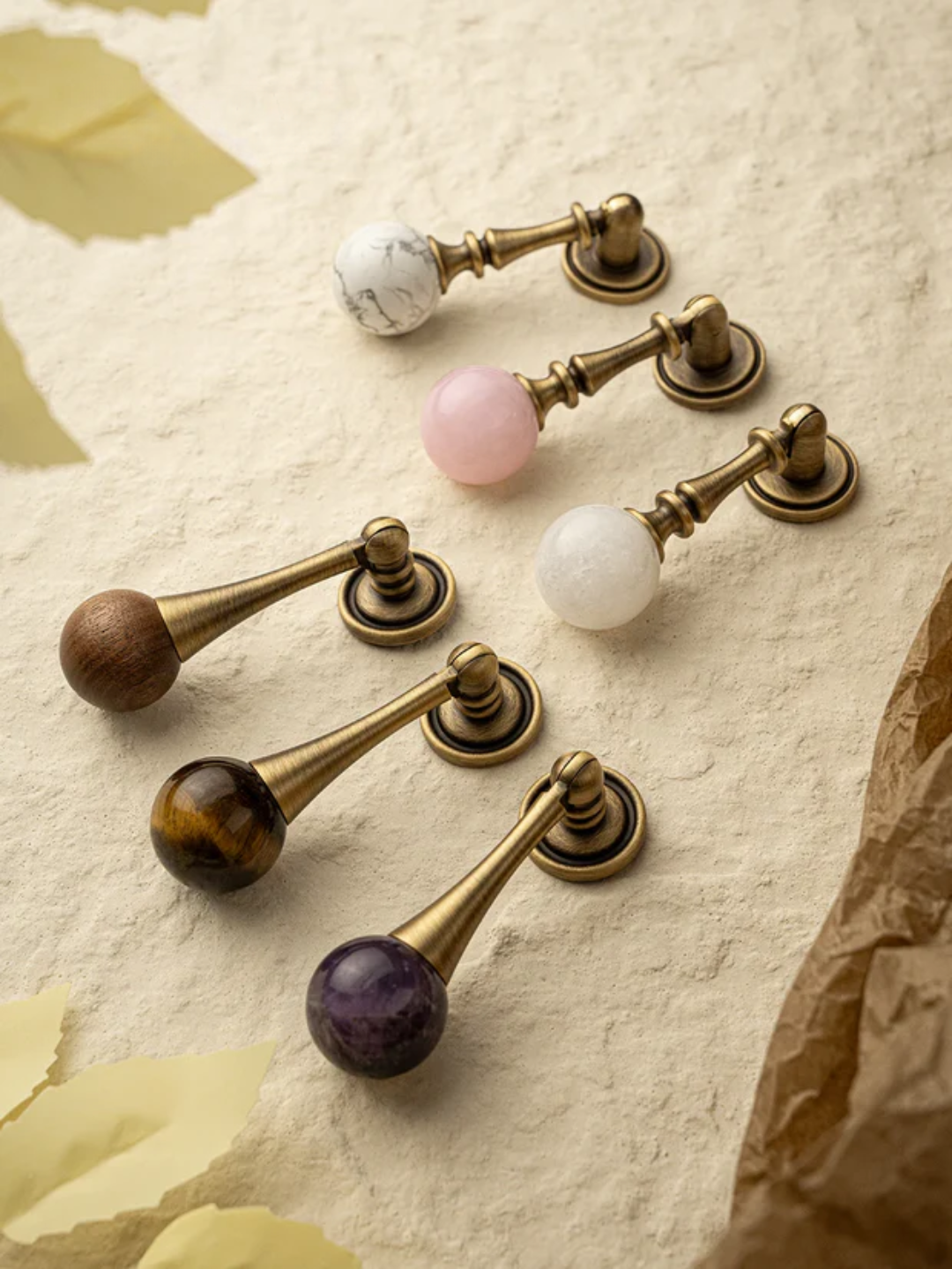 Decorative drawer pulls with gemstone knobs on a textured surface, featuring the Santaya brand.