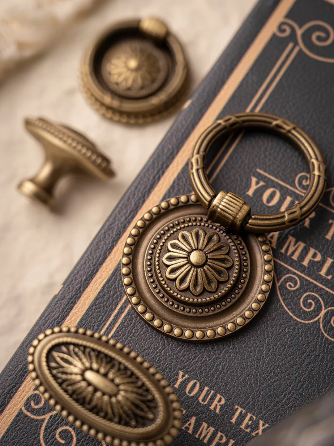 Bronze decorative keychain on a textured surface with text