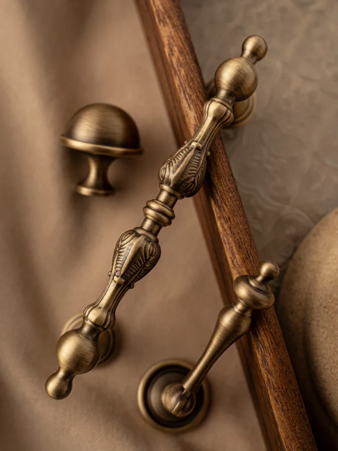 Close-up of ornate brass door handles on a wooden door.