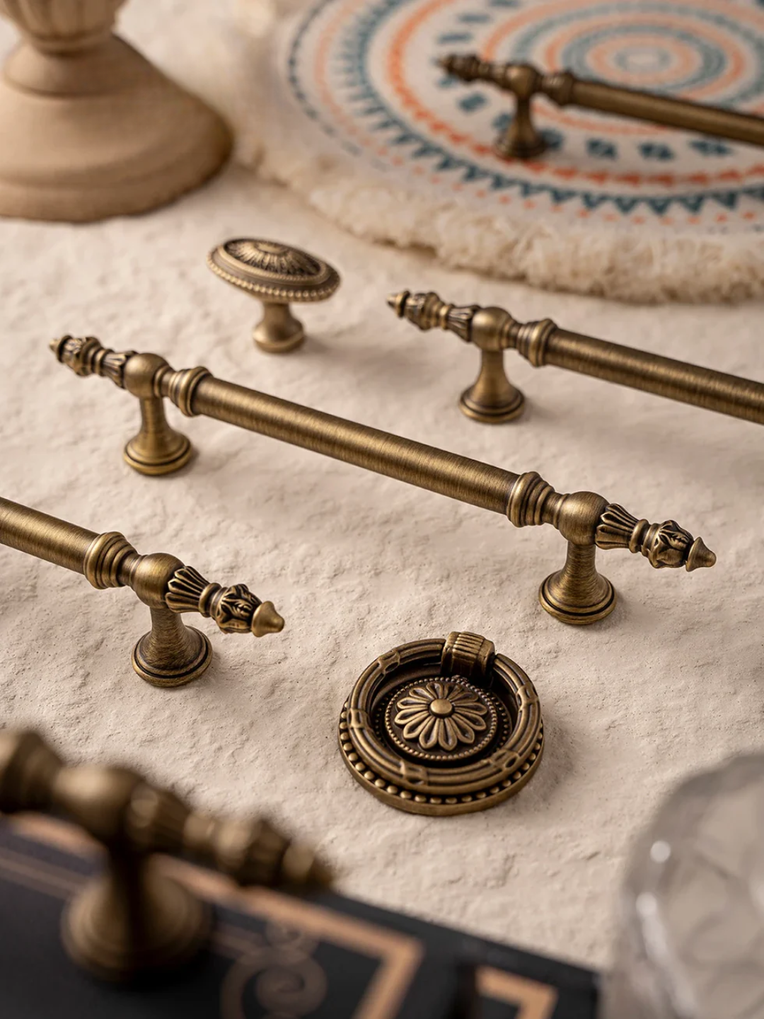 Collection of vintage-style brass hardware on a textured surface