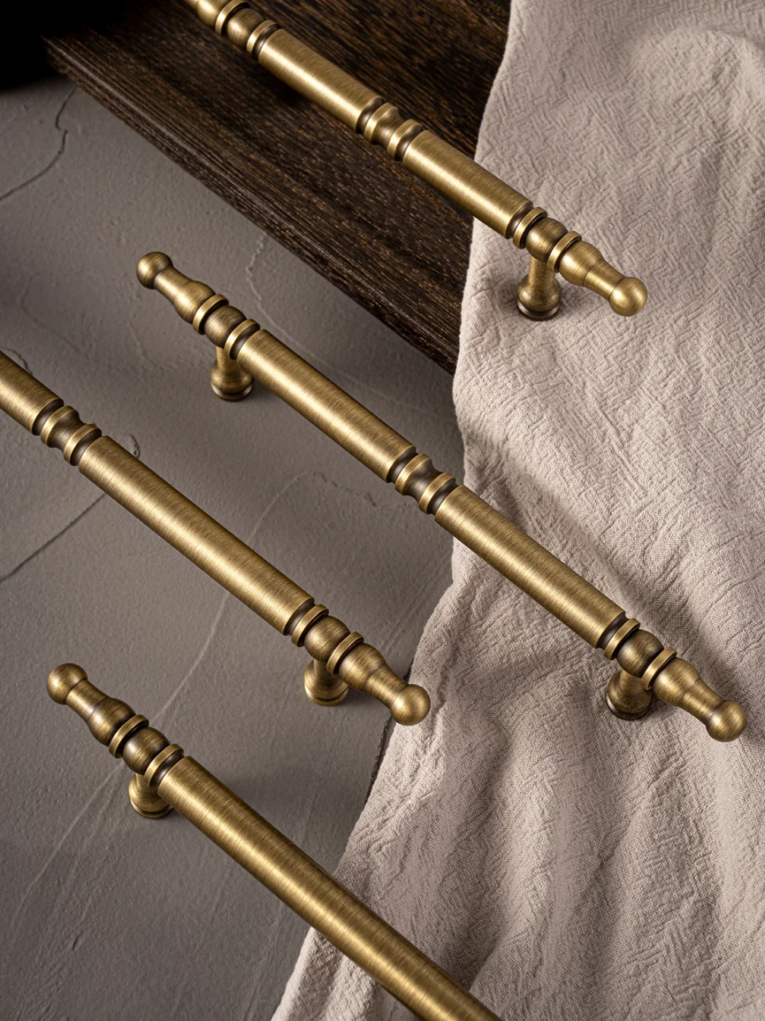 Set of gold cabinet handles on a neutral background