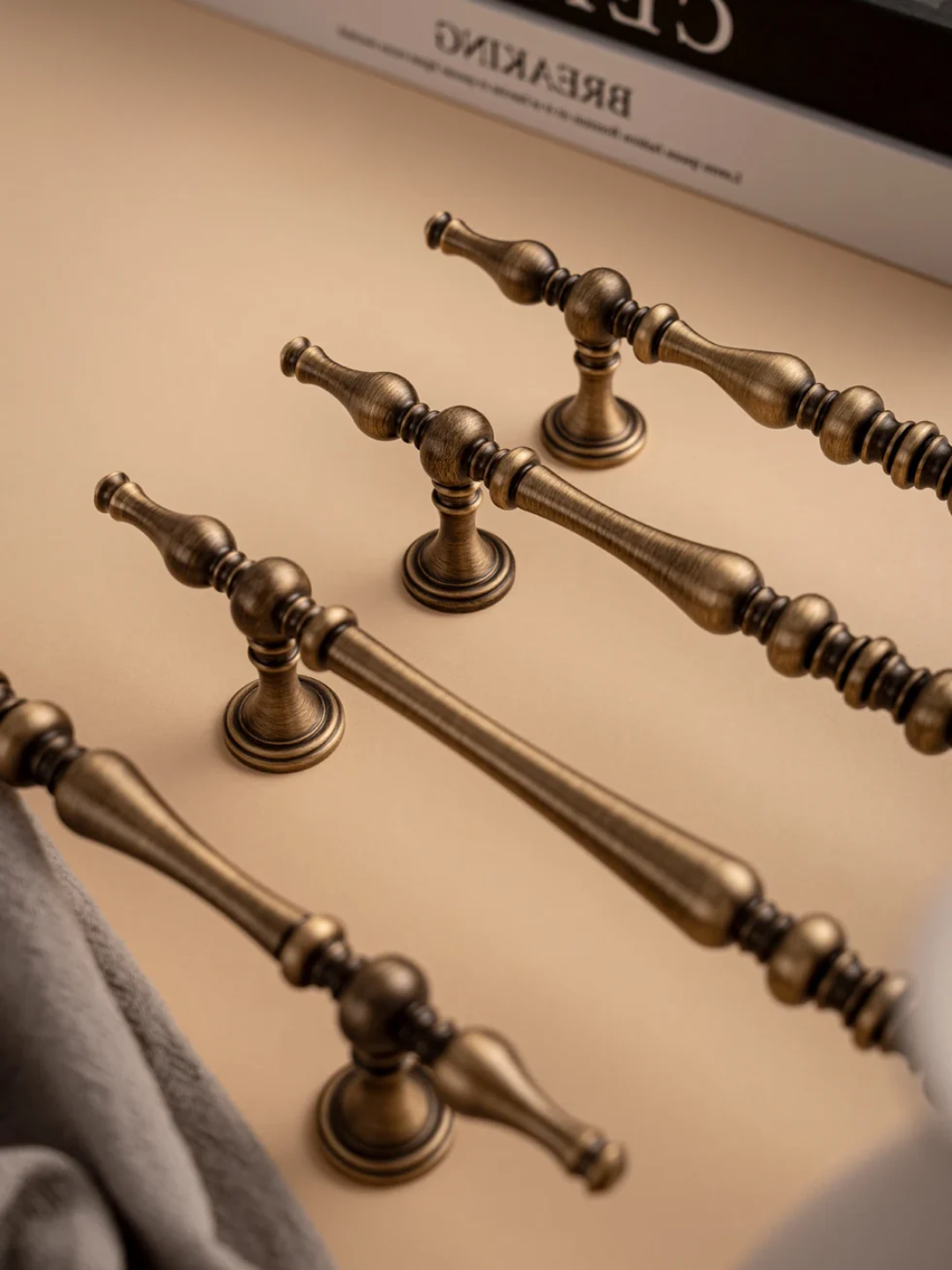 Set of bronze door handles on a beige surface