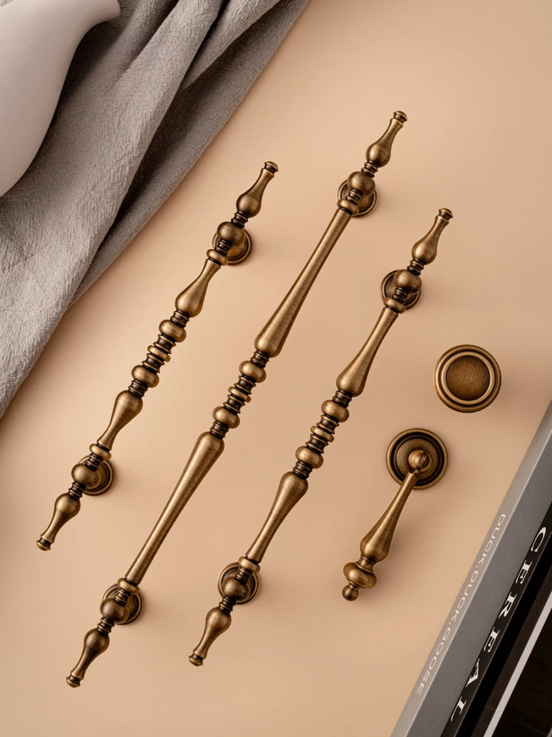 Set of bronze door handles on a beige surface