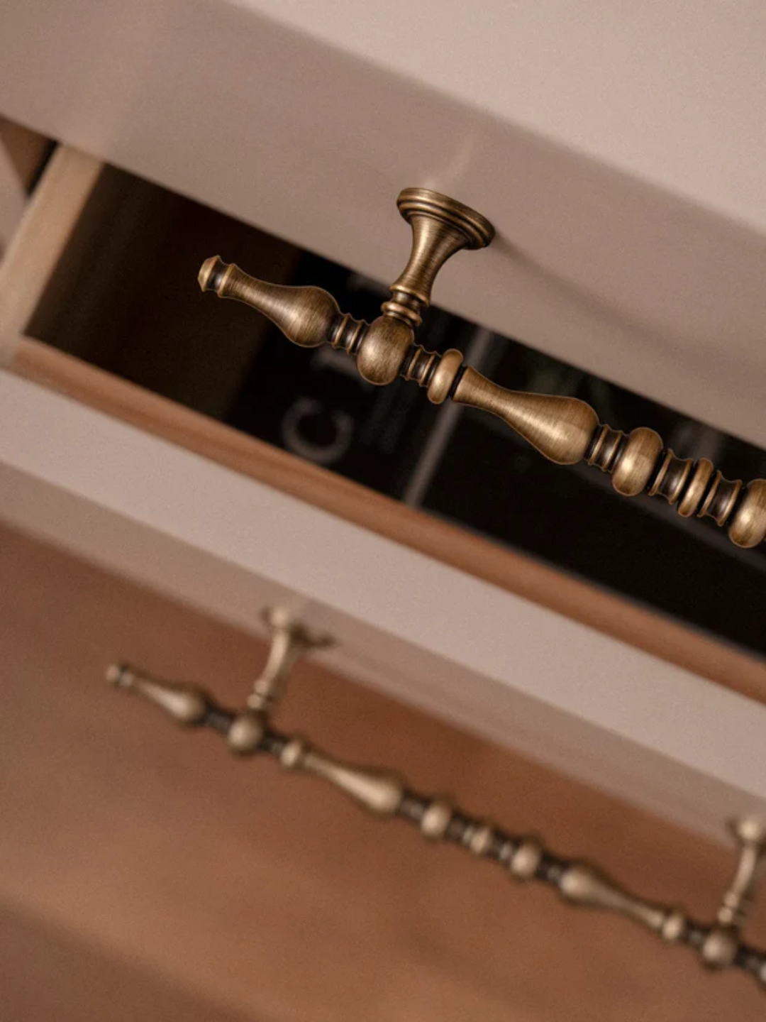 Close-up of a wooden drawer with brass handles