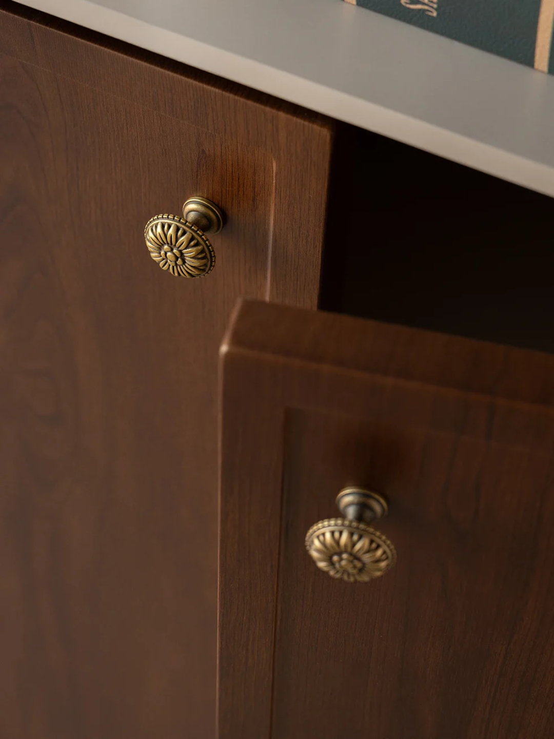Close-up of wooden cabinet doors with brass handles
