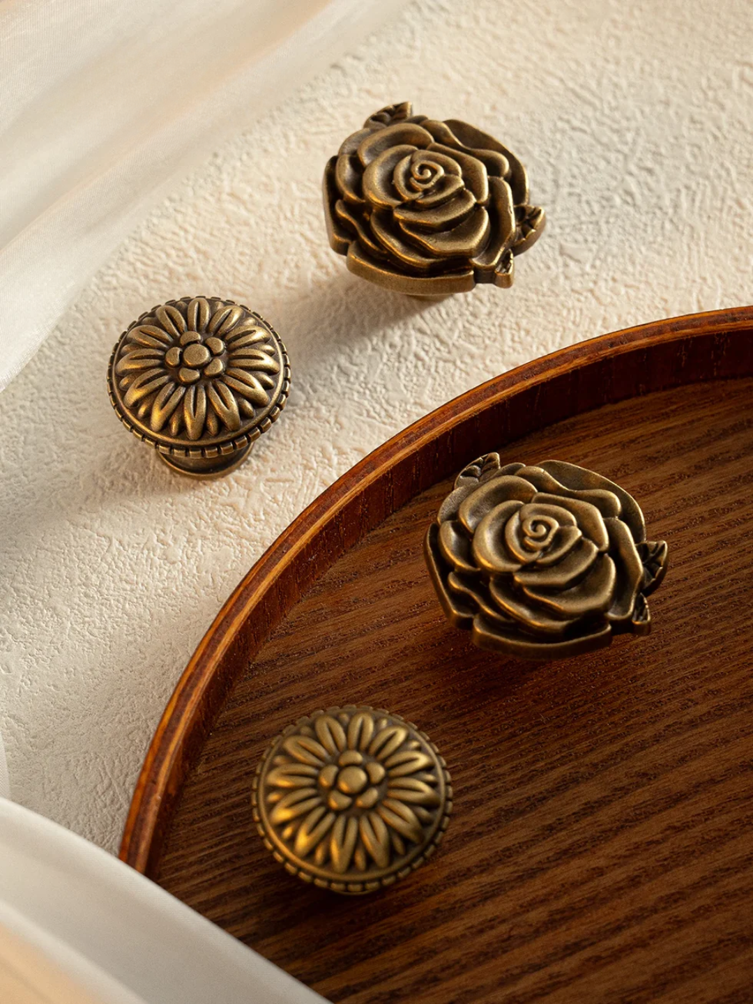 Bronze floral and circular decorative elements on a wooden surface
