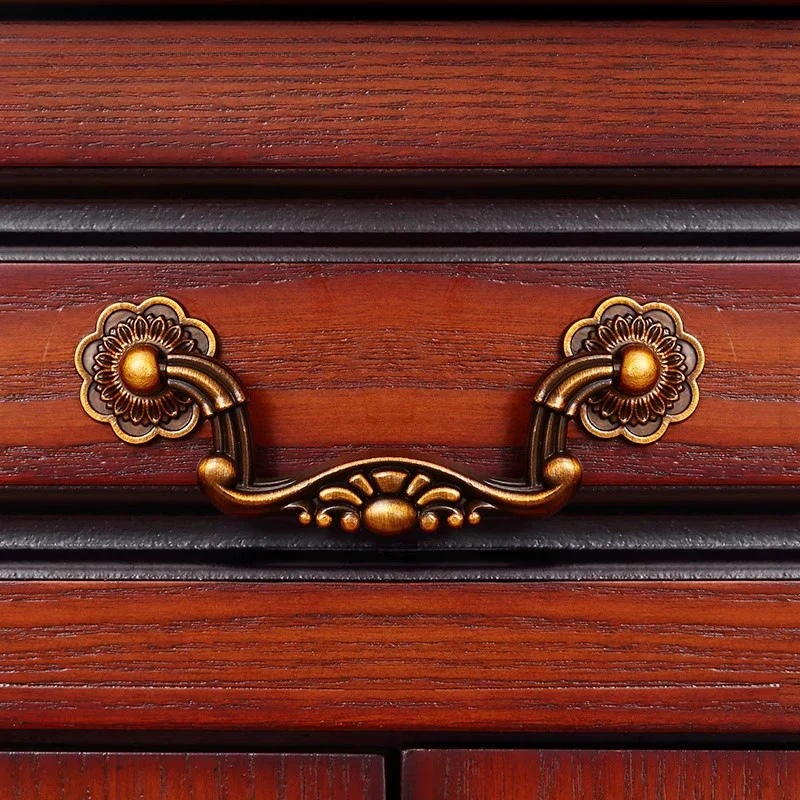 Wooden drawer with ornate brass handles