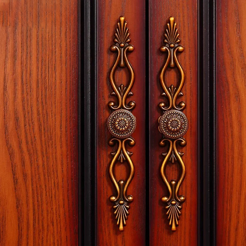 Decorative bronze handles on a wooden cabinet