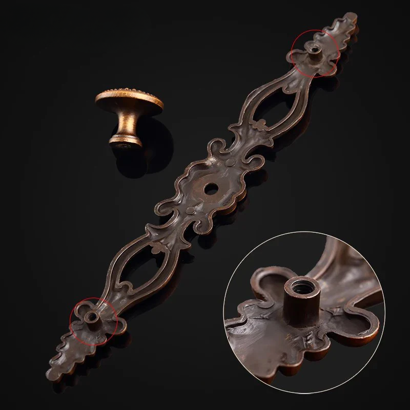 Decorative metal candle holder with intricate design on a dark background