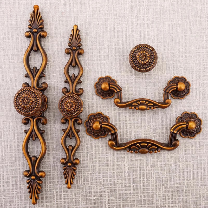 Decorative bronze cabinet handles and knobs on a black background