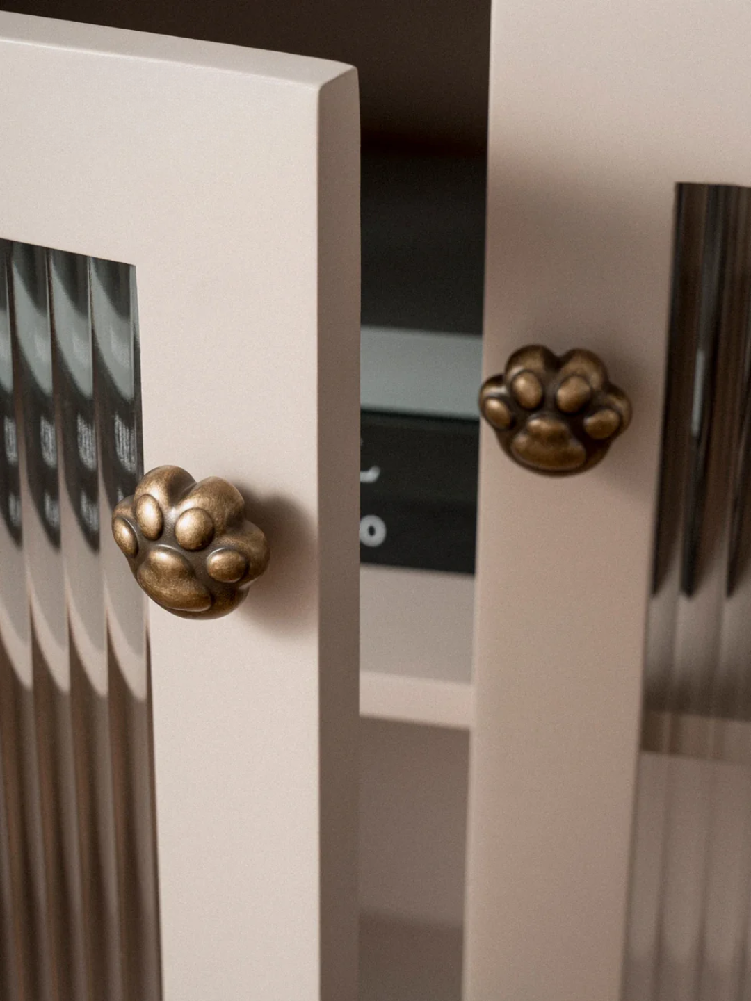 Close-up of a cabinet with decorative brass knobs on a blurred background