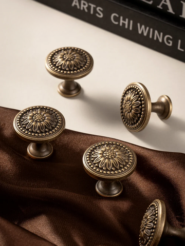 Set of bronze cabinet knobs on a brown fabric background