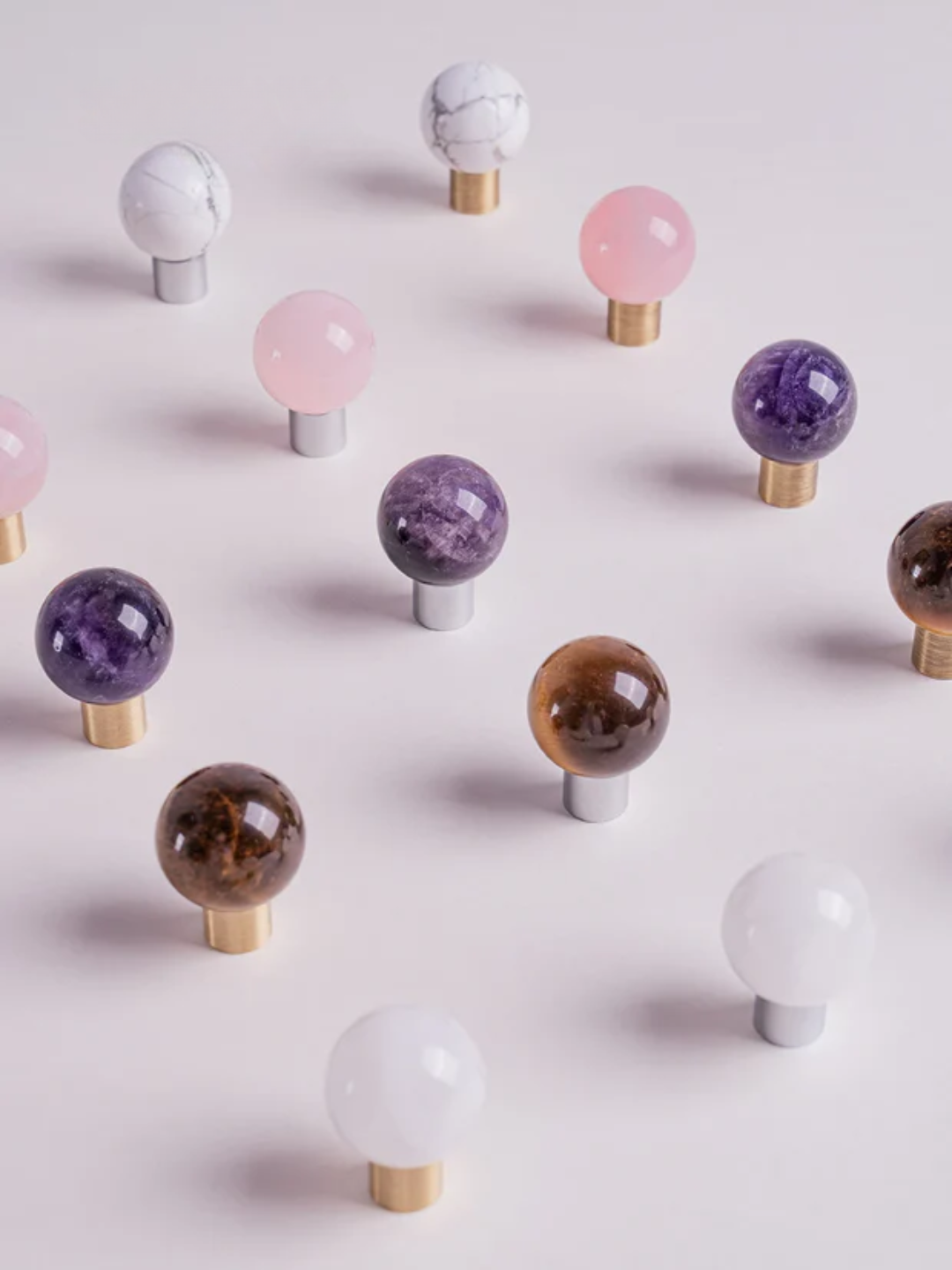 Colorful crystal balls on a light pink background