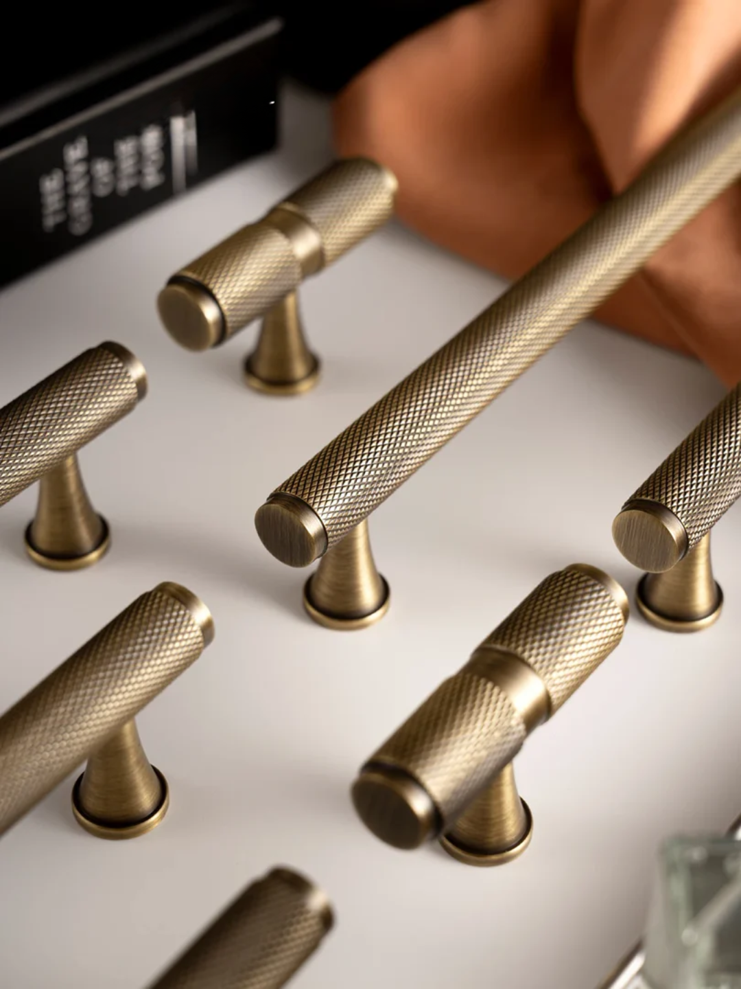 Collection of gold cabinet knobs on a white surface